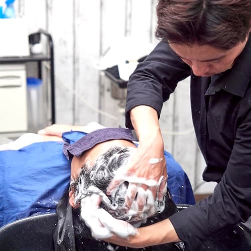 client gets his hair washed at the Japanese barber's in Düsseldorf Germany